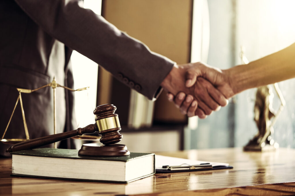 real estate attorney shaking hands with client at closing